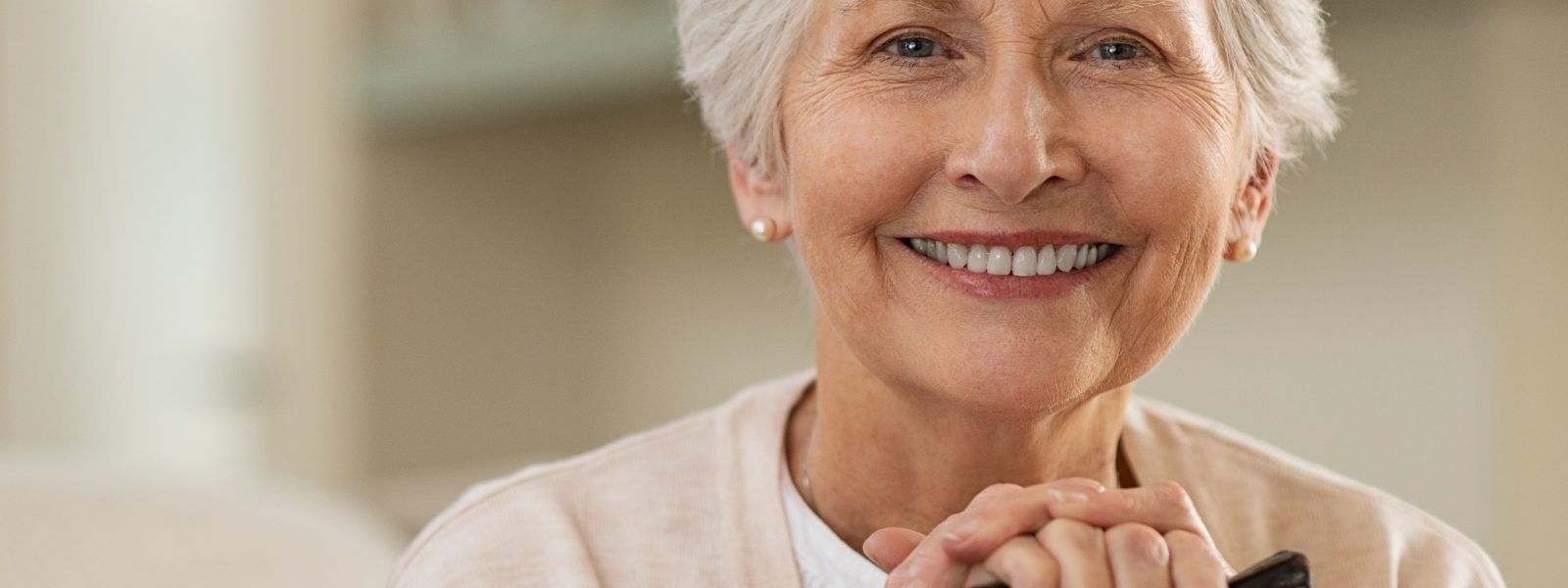 Older woman with pretty teeth smiling. This is dental work done right