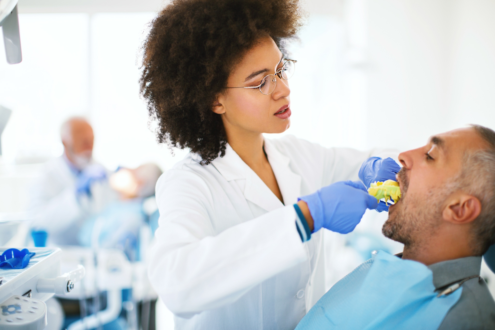 Local dentist providing professional cleaning patients teeth